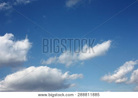 Blue Blue Sky With White Fluffy Clouds.