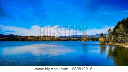 View Of The Regajo Reservoir With The Mountains In The Background