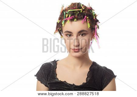 Young Woman With Hair Curlers On Head Isolated On White Background
