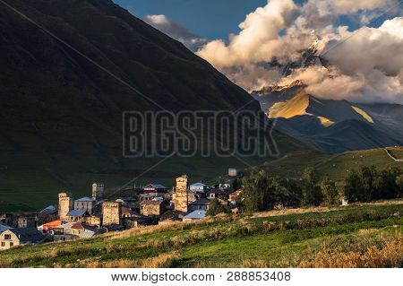 Mountain Landscape With Famous Georgian Village Ushguli In The Sunset Light, Copyspace On The Dark M