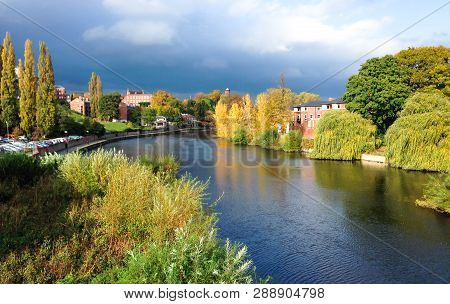 The River Severn Passing Through Shrewsbury In Shropshire, England. Photographed During A Sunny Peri