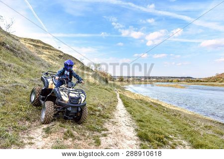The Boy Is Traveling On An Atv. Beautiful View.