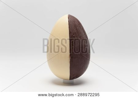 Delicious homemade Easter egg, two flavors: coconut and truffle. Isolated on white background. Horizontal image. Space for text. Close-up.