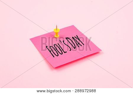 April Fools' Day Text Celebration Background With Paper Sticky Note And Office Pin On Pink Backgroun