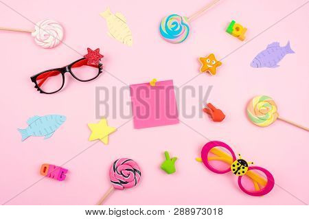April Fools' Day Celebration Background With Paper Fish, Sticky Note And Decor On Pink Background. A