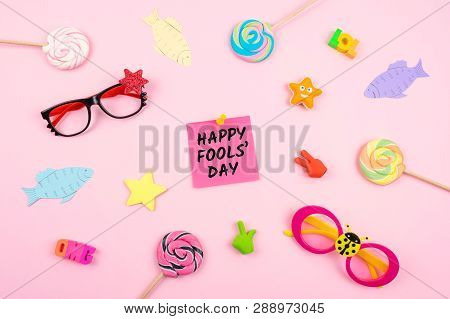 April Fools' Day Celebration Background With Paper Fish, Sticky Note And Decor On Pink Background. A