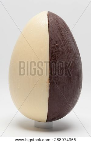 Delicious homemade Easter egg, 2 flavors: coconut and truffle. Isolated on white background. Vertical image. Close-up.