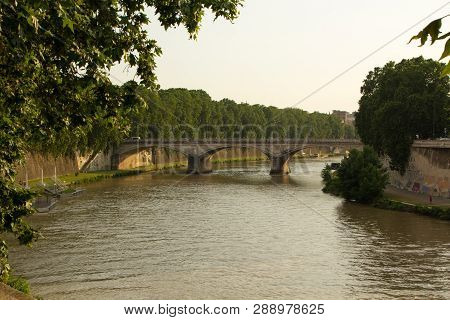 Evening Time On The Tiber River, Rome, Italy. Bridge And Embankment On The Tiber River, Rome.