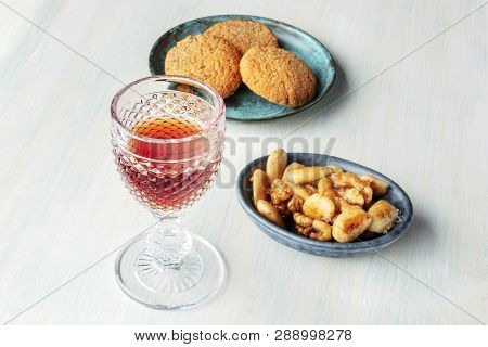 A Photo Of A Glass Of Sweet Wine With Cookies And Nuts, With A Place For Text