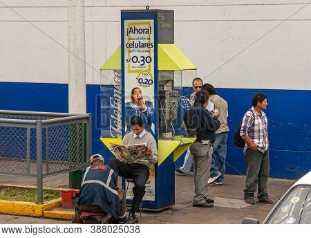Lima, Peru - December 4, 2008: Along Street, Telefonica Telephone Booth With Advertisement Posters A