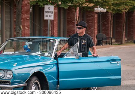 Toronto, Canada - 08 18 2018: Owner Of An Oldtimer Car Is Getting Into His 1967 Ford Thunderbird Har