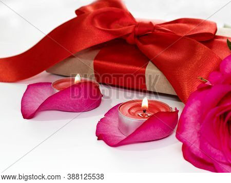 Festive Romantic Atmosphere. Rose Petals, Candles And Flowers On A Light Background. Selective Focus