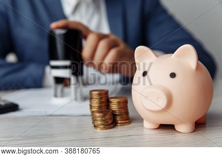 Pink Piggy Bank With Stack Of Coins On Desk In Office. Save Money And Management Financial Concept
