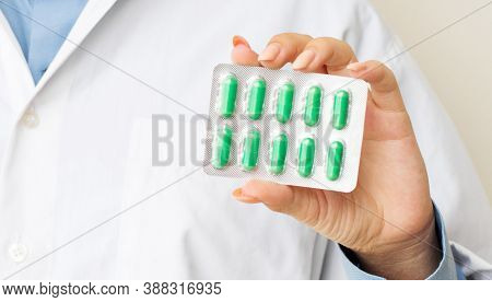 Female Doctor Showing Pills In The Hands Of A Close-up. The Appointment Of Treatment.