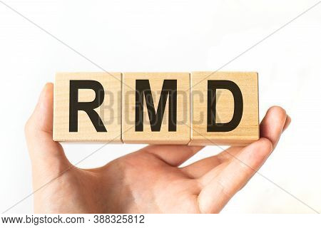 Hand Holds Wooden Cubes With Letters Rmd. Business Concept Image.
