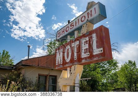 Shoshoni, Wyoming - July 25, 2020: Abandoned Shoshoni Motel, With Its Vintage Neon Sign Sits Decayin