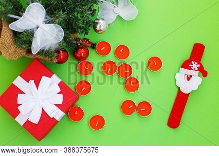 Christmas Composition. Christmas Gift, Presrnt Box, Many Red Candles And Fir Tree Branches With Toys