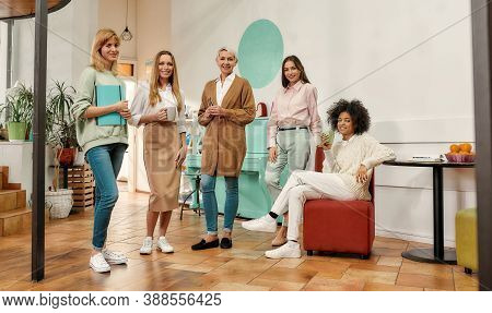 Coffee Break. A Group Of Five Creative Women Of Different Age Dressed Fashionably Standing Together 