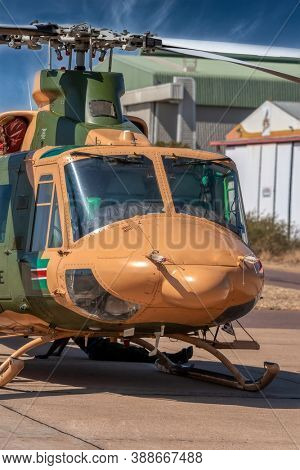 military helicopter in camouflage on the ground at the airbase