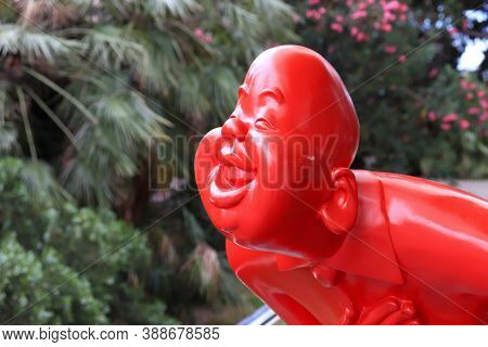 Sochi, Russia - June 13, 2019: Kitch, Popart Red Figure Of Smiling Bowing Person Man Symbolizing Hos