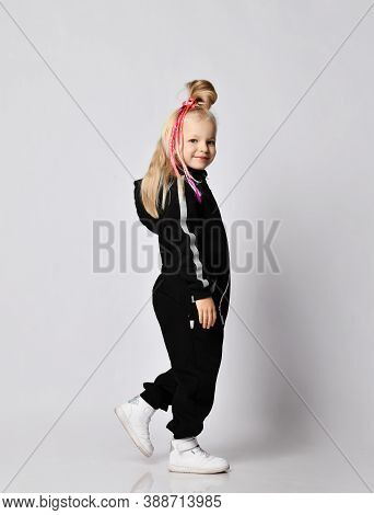 Frolic Playful Blonde Kid Baby Girl With Modern Hairstyle And Colorful Braids In Stylish Black Jumps
