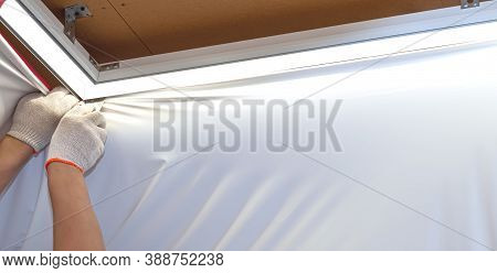 Repairers Make Installation Of A Stretch Ceiling