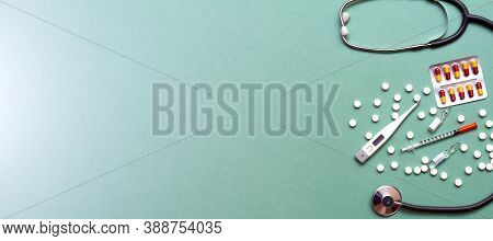 Pills, Ampoule, Syringes, Capsules, Stethoscope On The Green Doctor S Table. Copy Space. Place For T