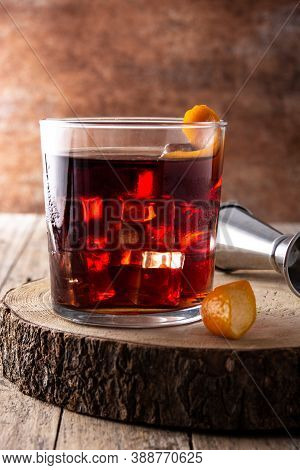 Boulevardier Cocktail And Orange Zest On Wooden Table