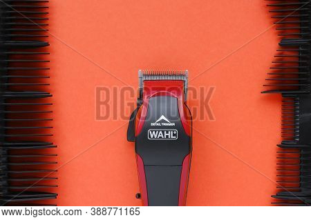 Kharkov, Ukraine - July 2, 2020 : Hairdressers Tool. Hair Clipper Wahl Close-up On A Red Background 
