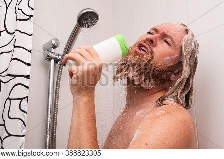 Handsome Bearded Man Singing While Taking Shower At Home Using Shampoo Bottle Instead Of Microphone.