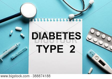 Diabetes Type 2 Written On A White Notepad On A Blue Background Near A Stethoscope, Syringe, Electro
