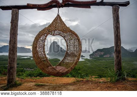 The Scenery Of The Sametnangshe Island Looks Through The Hanging Basket Wicker Chair In Phang-nga Pr