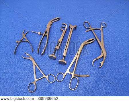 Many Surgical Bone Holding Forceps In Blue Background