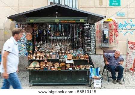 SARAJEVO, BOSNIA AND HERZEGOVINA - AUGUST 11, 2012: Salesman with traditional souvenirs on old town Bascarsija, popular place for tourists to buy local craftwork.