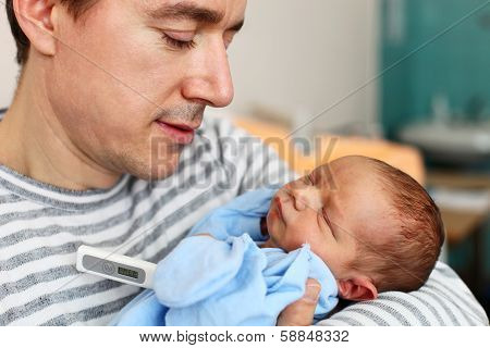 Father and newborn son with thermometer