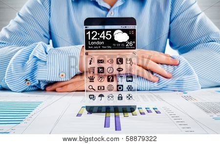 Smartphone (phablet) with a transparent display in human hands. Concept actual future innovative ideas and best technologies humanity.