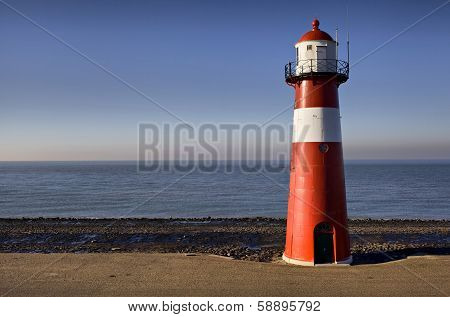 Red-white Lighthouse On The Coast Of North Sea At Westkapelle