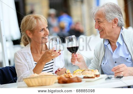 Senior couple eating Spanish fingerfood in Spain