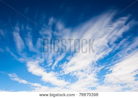 Dramatic blue sky background with streaky clouds