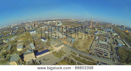 Cityscape with oil refinery in a sunny spring day, aerial view