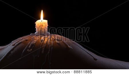 Body Scape Of A Well-shaped Woman With Burning Candle And Wax On Her Bum