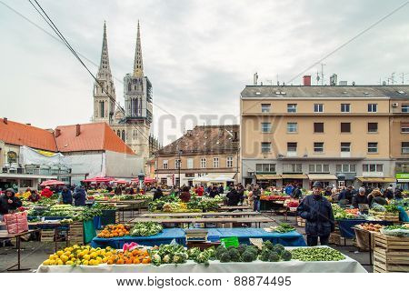 ZAGREB, CROATIA - 12 MARCH 2015: Dolac market full of fruits and vegetables with a view of Zagreb Cathedral.