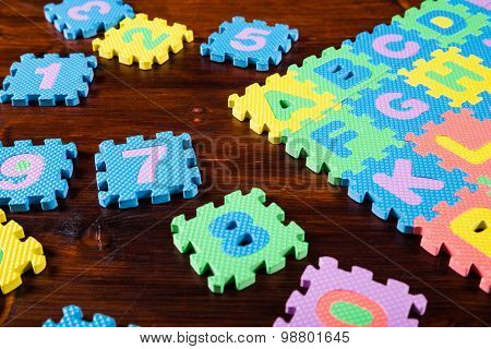colorful puzzle letters on wooden background