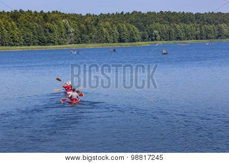 Couple Kayaking On Goldopiwo Lake, Mazury, Poland.