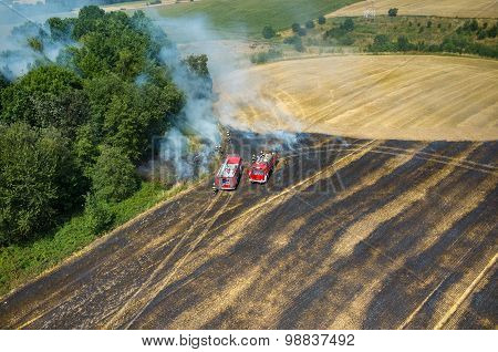 Fireman Truck Working On The Field On Fire