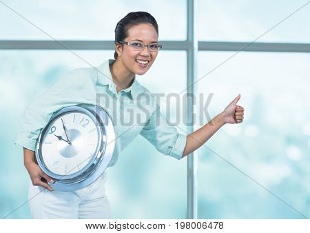 Digital composite of Woman holding clock in front of windows