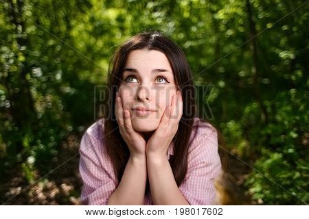 Portrait Of Dreamy Young Woman With Hands Over Face