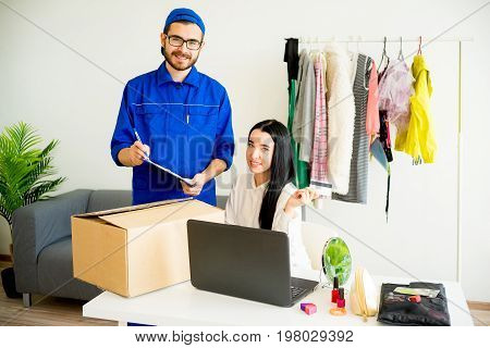 Woman accepting a box package from deliveryman