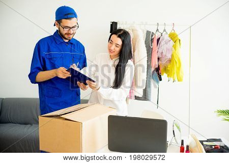 Woman accepting a box package from deliveryman