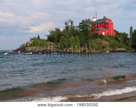 The red Marquette Harbor Lighthouse overlooks Lake Superior on the northern shore of the upper peninsula of Michigan and dates back to 1866. Marquette Michigan.